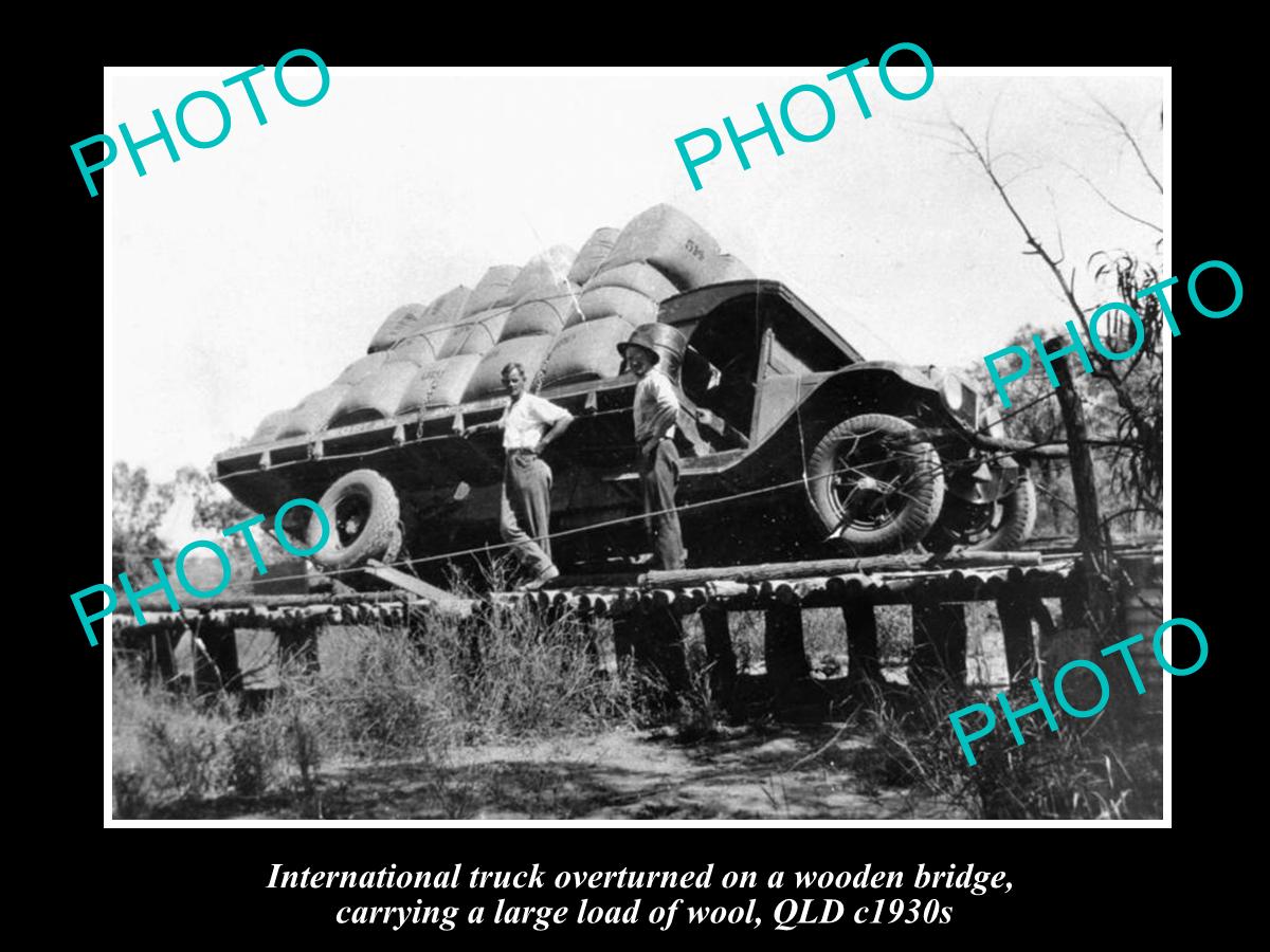 OLD HISTORIC PHOTO OF TRUCK OVERTURNED ON BRIDGE WITH LOAD OF WOOL, QLD 1930